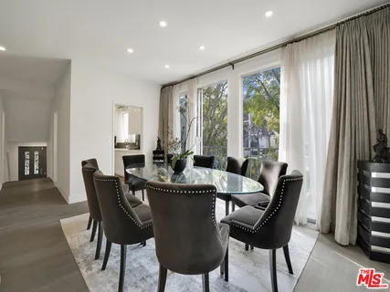 a dining room with furniture window and wooden floor
