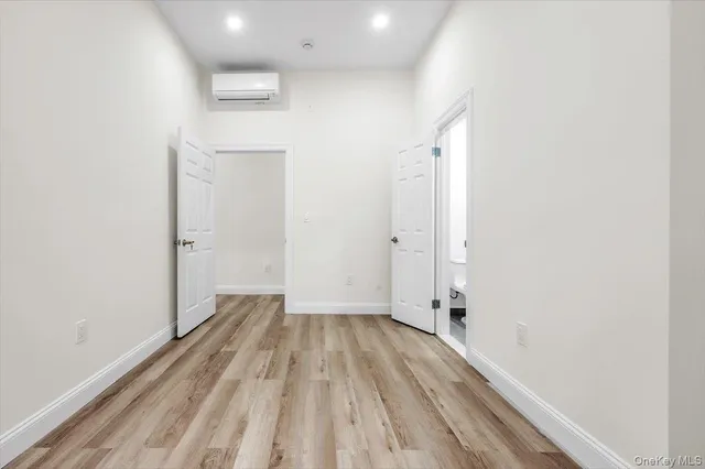a view of a room with wooden floor and a hallway