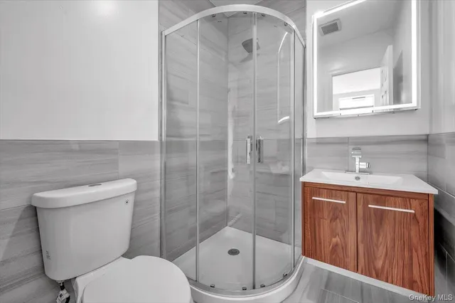 a bathroom with a toilet sink and shower