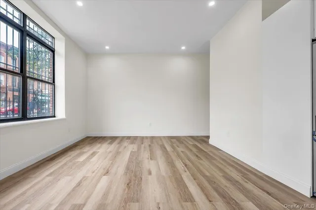 a view of room with window and hardwood floor