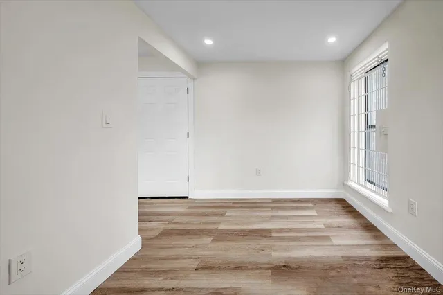 a view of room with window and hardwood floor