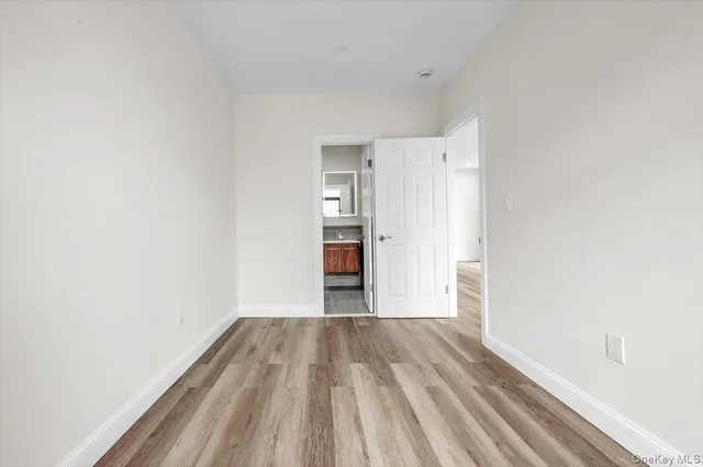 a view of a room with wooden floor and a ceiling fan