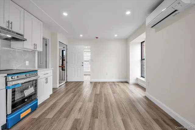 a view of a kitchen with wooden floor and a ceiling fan
