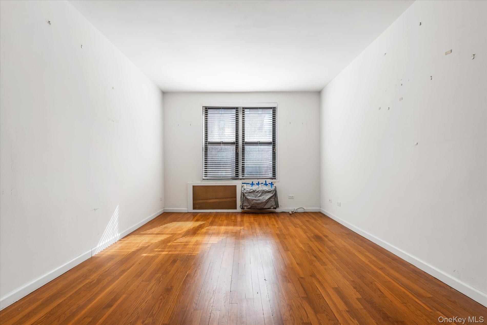 58-th Street West 400th, Unit 5G Manhattan, NY 10019 - Photo 11 of 18 Empty room featuring baseboards and hardwood / wood-style flooring