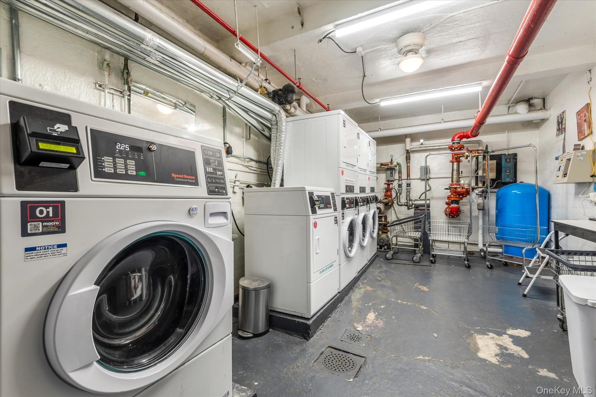 58-th Street West 400th, Unit 5G Manhattan, NY 10019 - Photo 15 of 18 Common laundry area featuring stacked washer and clothes dryer and washing machine and clothes dryer