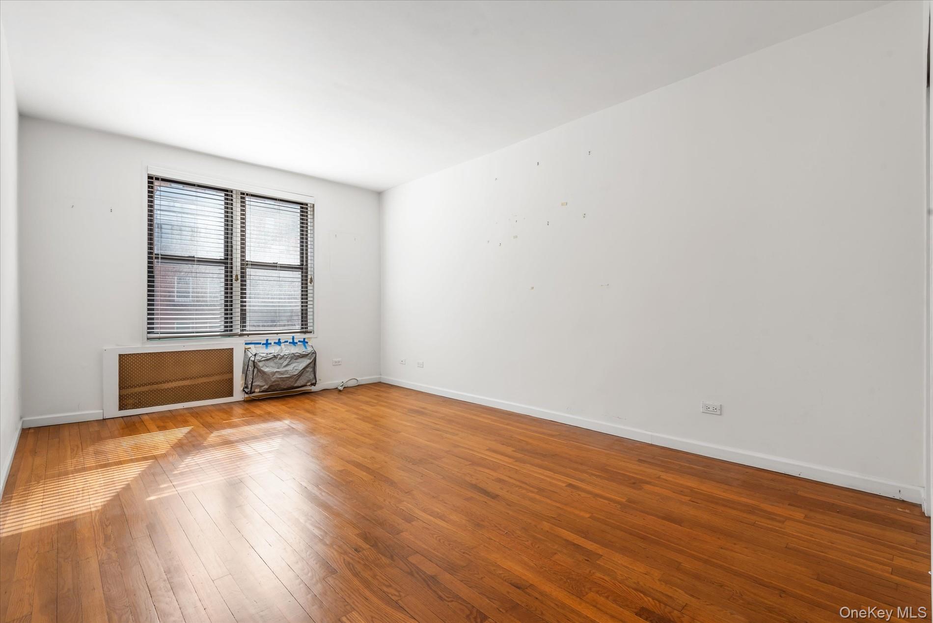 58-th Street West 400th, Unit 5G Manhattan, NY 10019 - Photo 10 of 18 Empty room with baseboards and wood-type flooring