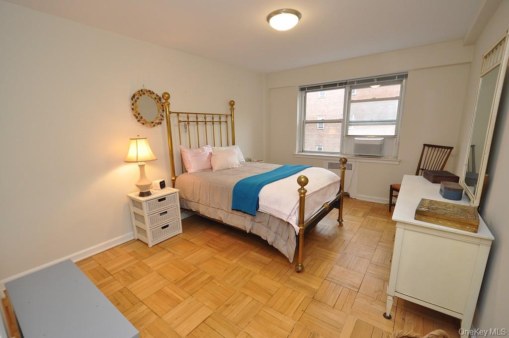 235 Garth Road, Unit A5B Scarsdale, NY 10583 - Photo 22 of 47 a bedroom with a bed and wooden floor