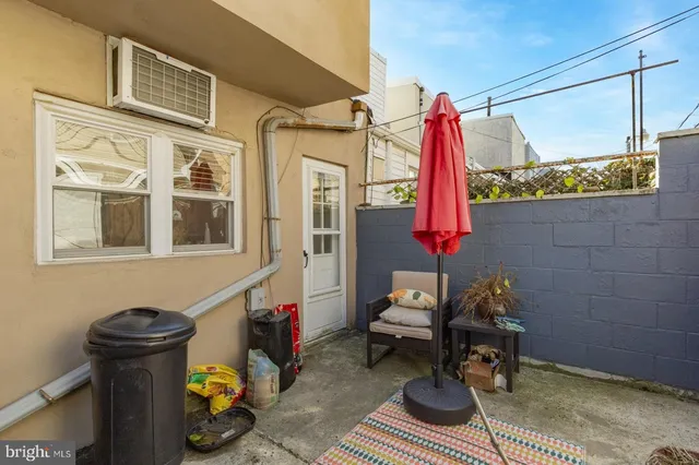 a front view of a house with outdoor seating