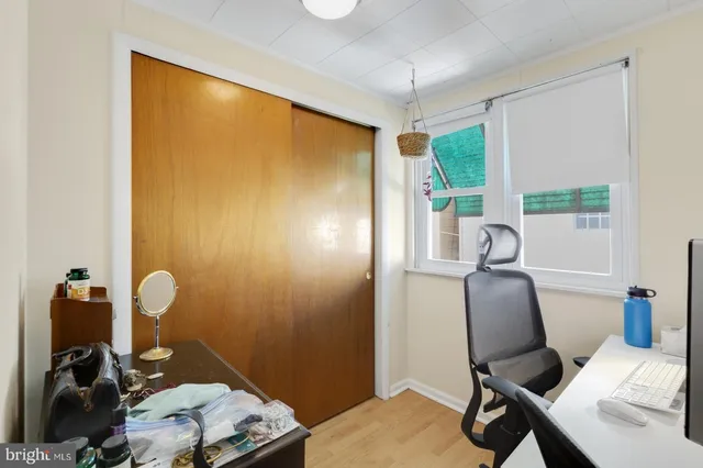 a view of a workspace with furniture and a window