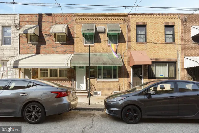 a front view of a house with parking space