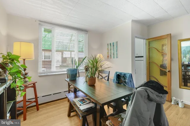 a view of a dining room with furniture and a potted plant
