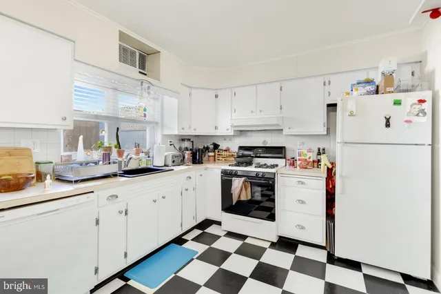 a kitchen with granite countertop appliances and cabinets