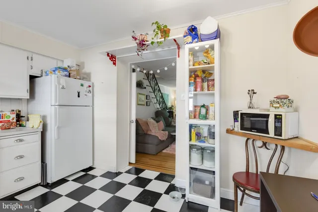 a kitchen with a refrigerator and cabinets