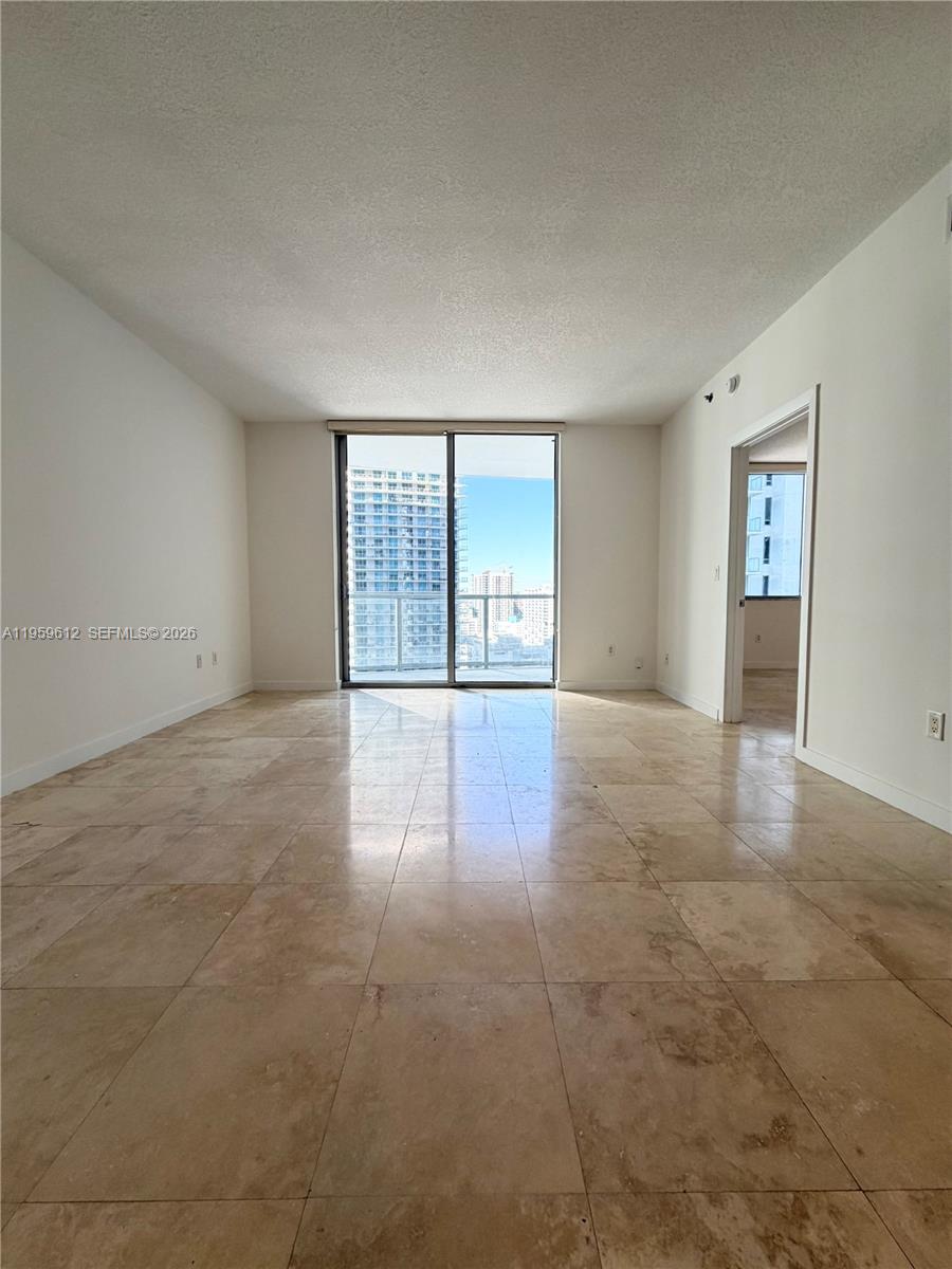 1060 Brickell Avenue, Unit 2113 Miami, FL 33131 - Photo 11 of 52 wooden floor in an empty room with a window