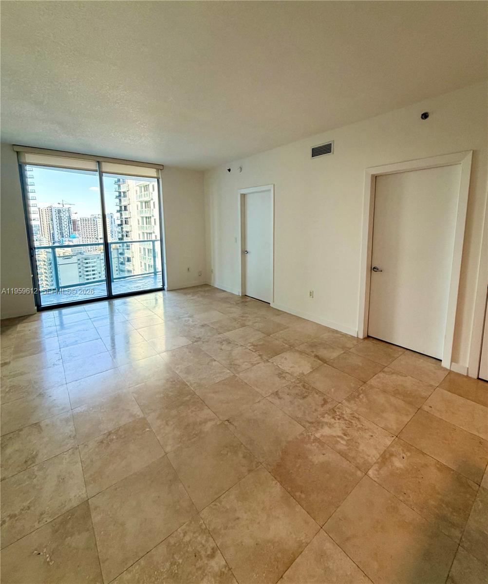 1060 Brickell Avenue, Unit 2113 Miami, FL 33131 - Photo 16 of 52 a view of an empty room with glass door