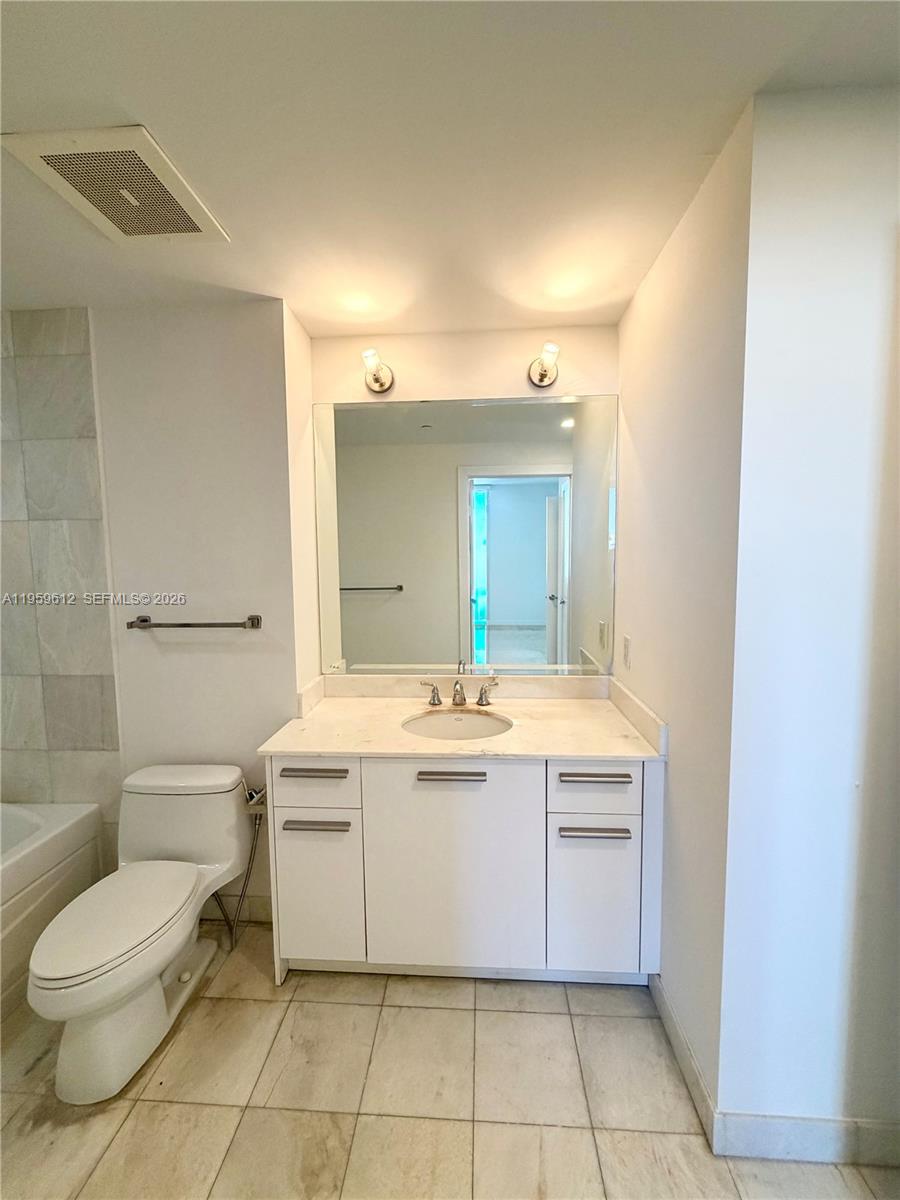 1060 Brickell Avenue, Unit 2113 Miami, FL 33131 - Photo 24 of 52 a bathroom with a sink a toilet and shower