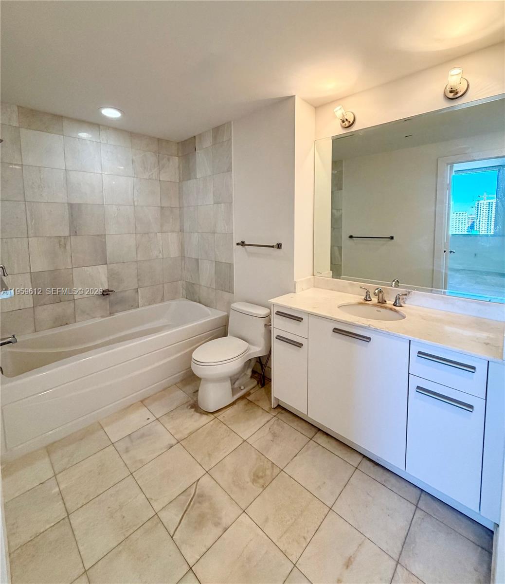 1060 Brickell Avenue, Unit 2113 Miami, FL 33131 - Photo 25 of 52 a bathroom with a sink a toilet and shower