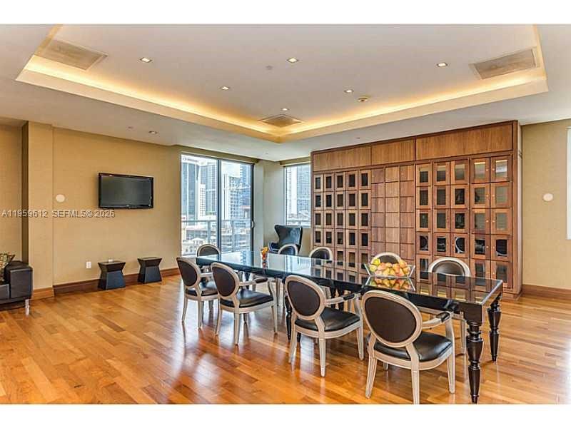 1060 Brickell Avenue, Unit 2113 Miami, FL 33131 - Photo 49 of 52 a view of a dining room with furniture and wooden floor