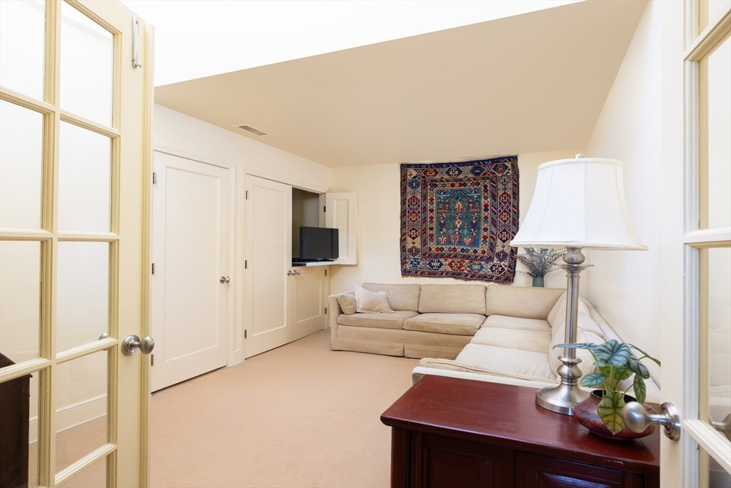 227 Summit Avenue, Unit E405 Brookline, MA 02446 - Photo 11 of 15 a living room with furniture and a large window