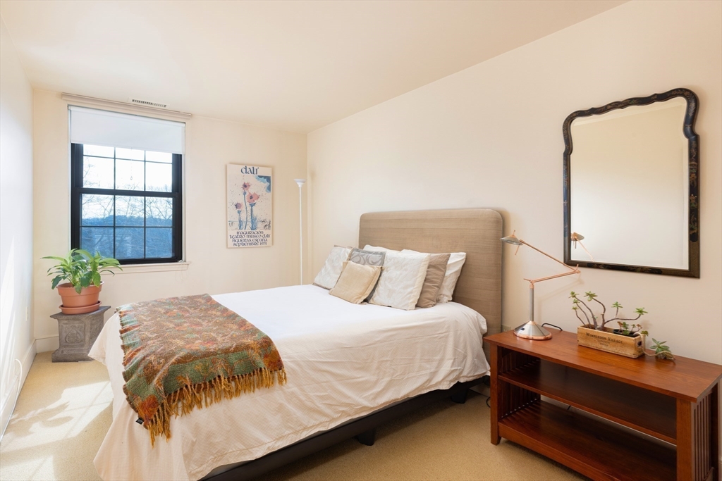 227 Summit Avenue, Unit E405 Brookline, MA 02446 - Photo 13 of 15 a bedroom with a bed and window