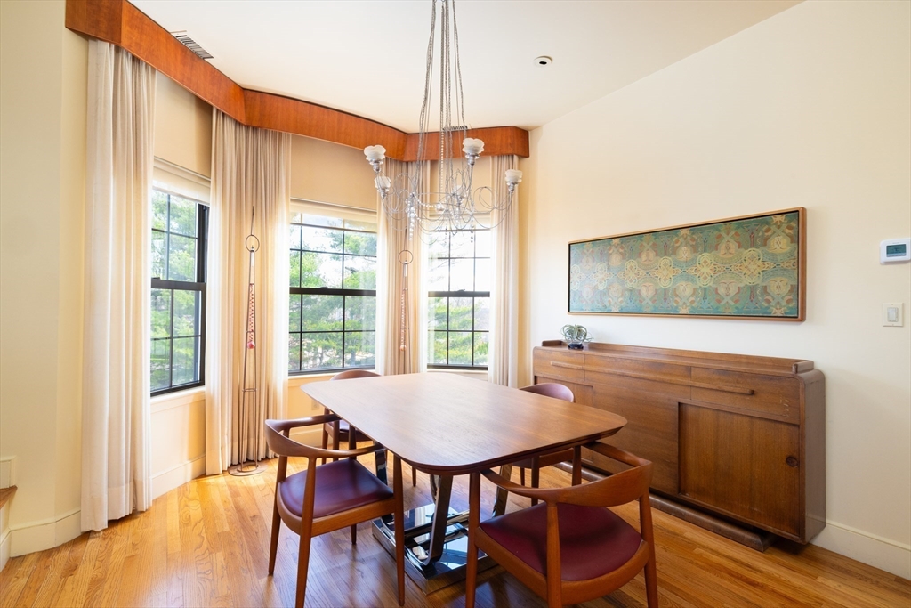 227 Summit Avenue, Unit E405 Brookline, MA 02446 - Photo 5 of 15 a view of a dining room with furniture window and wooden floor