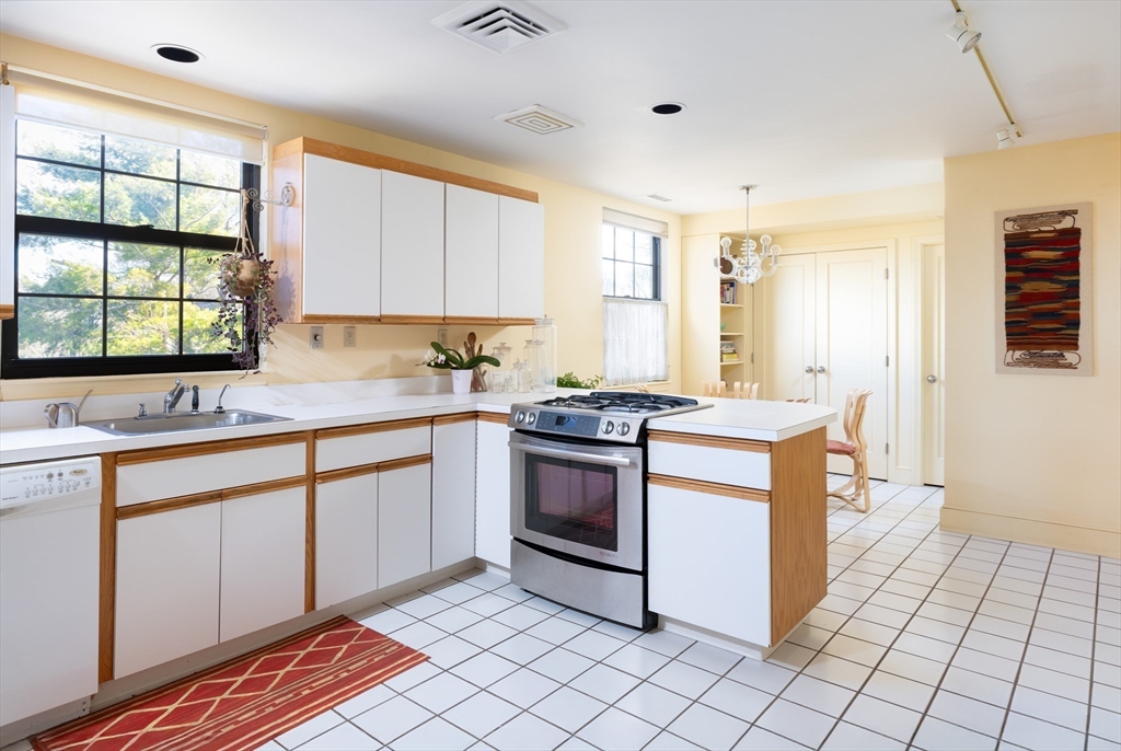 227 Summit Avenue, Unit E405 Brookline, MA 02446 - Photo 6 of 15 a kitchen with a stove sink and cabinets