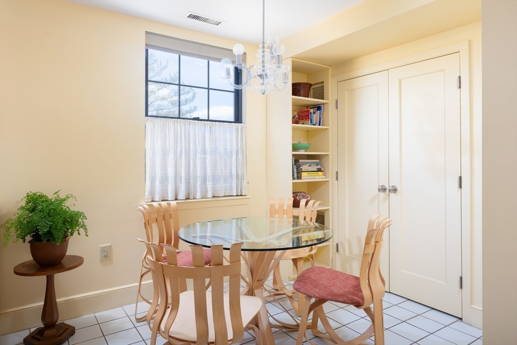 227 Summit Avenue, Unit E405 Brookline, MA 02446 - Photo 7 of 15 a view of a dining room with furniture and a potted plant