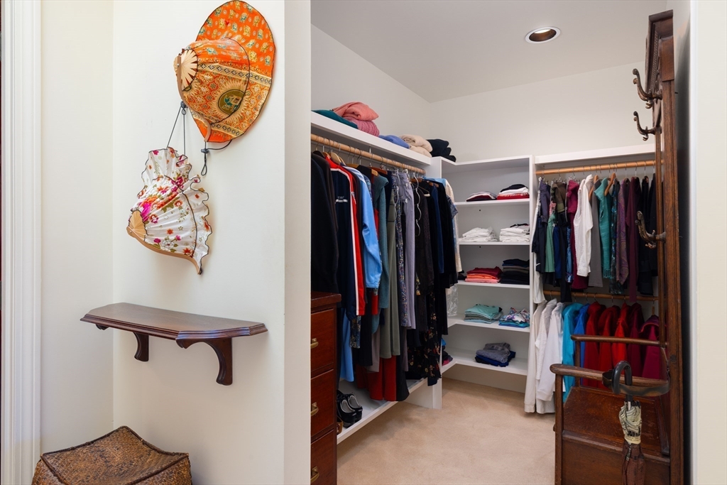 227 Summit Avenue, Unit E405 Brookline, MA 02446 - Photo 9 of 15 a view of walk in closet with clothes and shoes