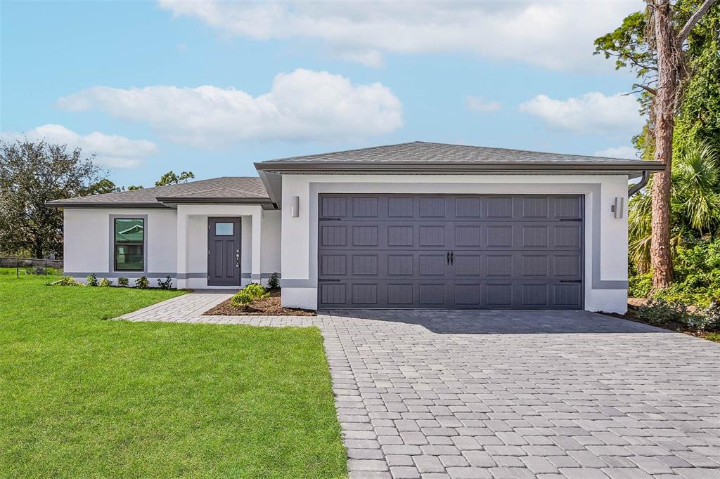 4187 Welland Terrace North Port, FL 34286 - Photo 1 of 1 a front view of a house with a yard and garage