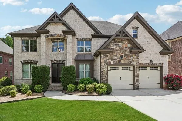 a front view of a house with a yard and garage