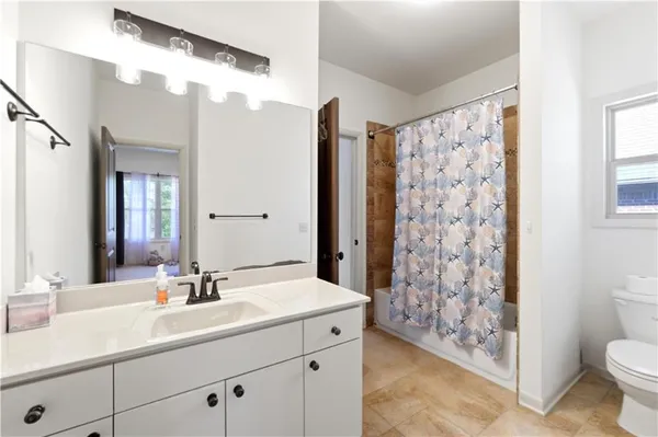 a bathroom with a double vanity sink toilet and shower