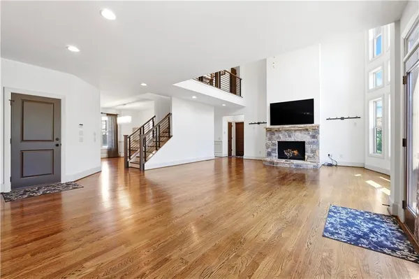 a view of a livingroom with wooden floor and a fireplace