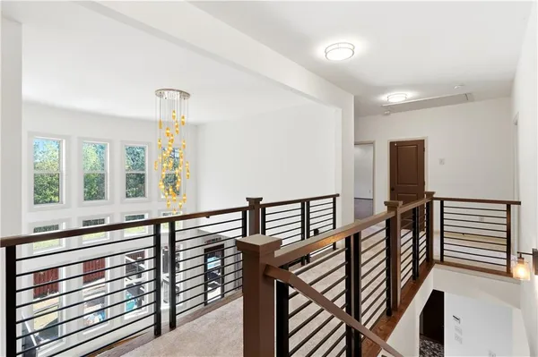 a view of entryway and hall with wooden floor