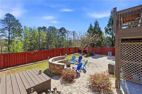 a front view of a house with a yard fire pit and outdoor seating