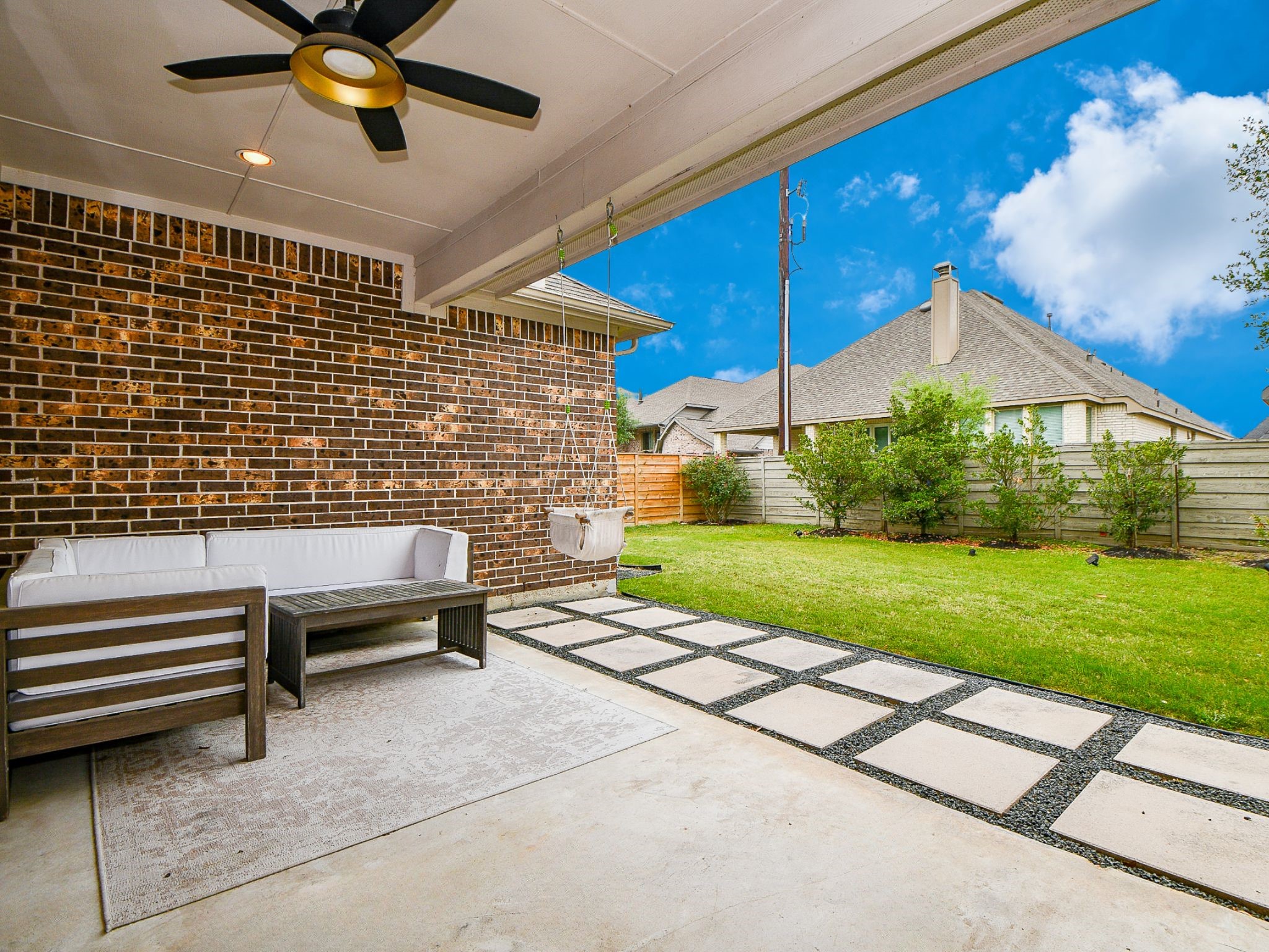 4523 Juniper Ridge Lane Manvel, TX 77578 - Photo 37 of 38 a backyard of a house with a garden and outdoor seating
