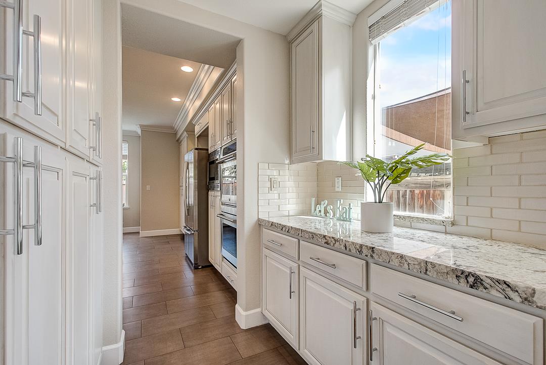 7108 Lahinch Drive Gilroy, CA 95020 - Photo 11 of 50 a kitchen with stainless steel appliances granite countertop a sink and a granite counter tops