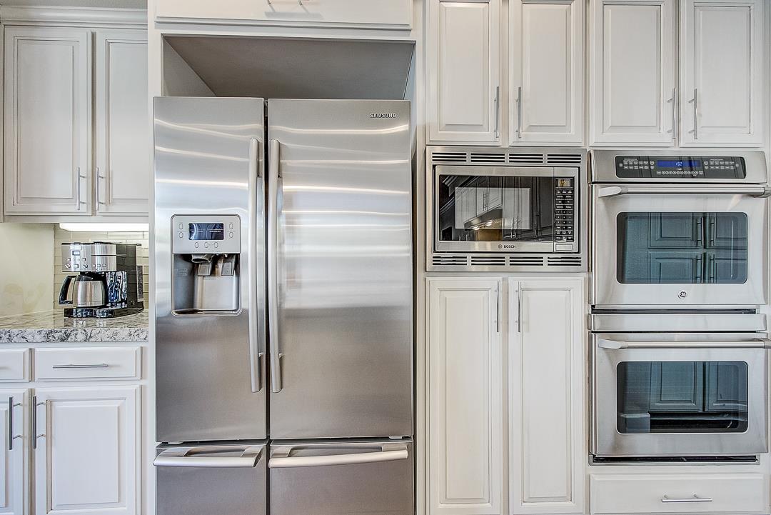 7108 Lahinch Drive Gilroy, CA 95020 - Photo 14 of 50 a kitchen with stainless steel appliances granite countertop a refrigerator and a stove top oven