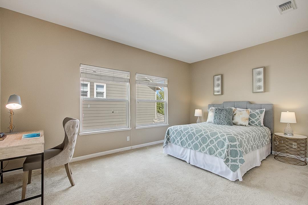 7108 Lahinch Drive Gilroy, CA 95020 - Photo 22 of 50 a bedroom with a bed and a table in it