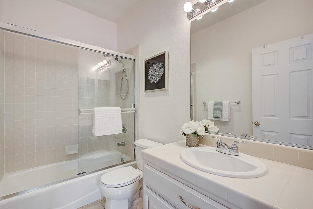 7108 Lahinch Drive Gilroy, CA 95020 - Photo 23 of 50 a bathroom with a bathtub shower sink mirror vanity and toilet