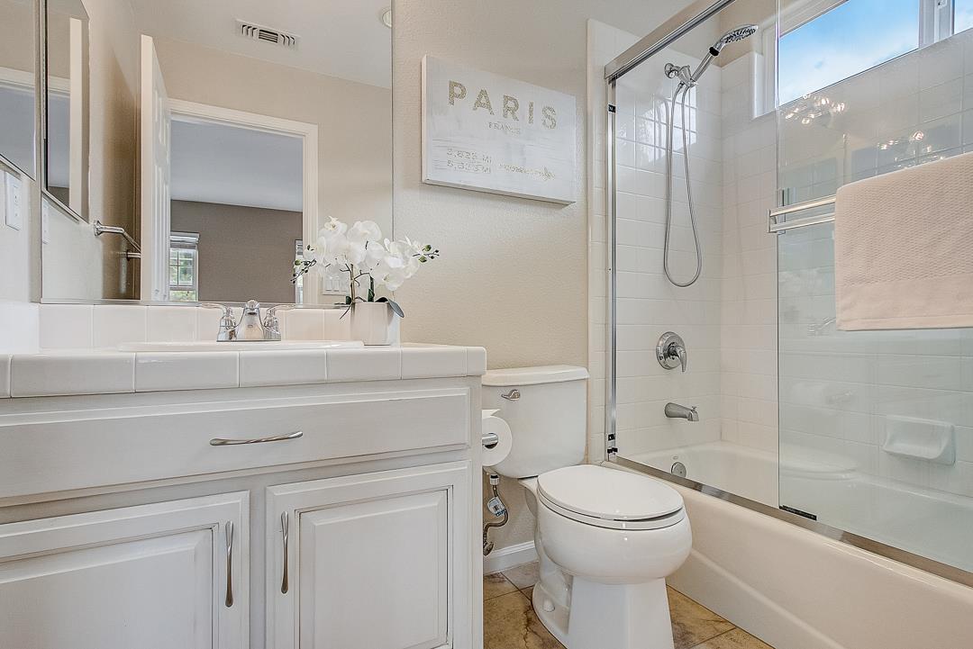 7108 Lahinch Drive Gilroy, CA 95020 - Photo 28 of 50 a bathroom with a toilet sink vanity granite and shower