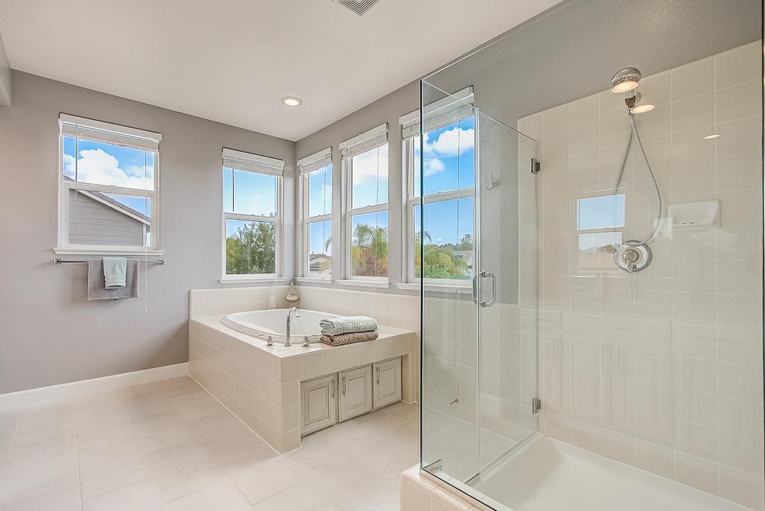 7108 Lahinch Drive Gilroy, CA 95020 - Photo 35 of 50 a bathroom with a tub a sink and a shower