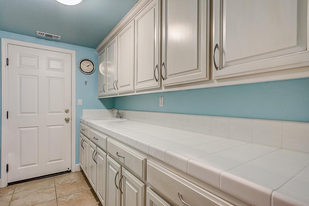 7108 Lahinch Drive Gilroy, CA 95020 - Photo 42 of 50 a kitchen with cabinets and a refrigerator