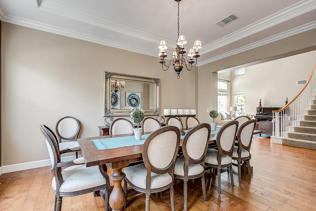 7108 Lahinch Drive Gilroy, CA 95020 - Photo 8 of 50 a view of a dining room with furniture chandelier and wooden floor