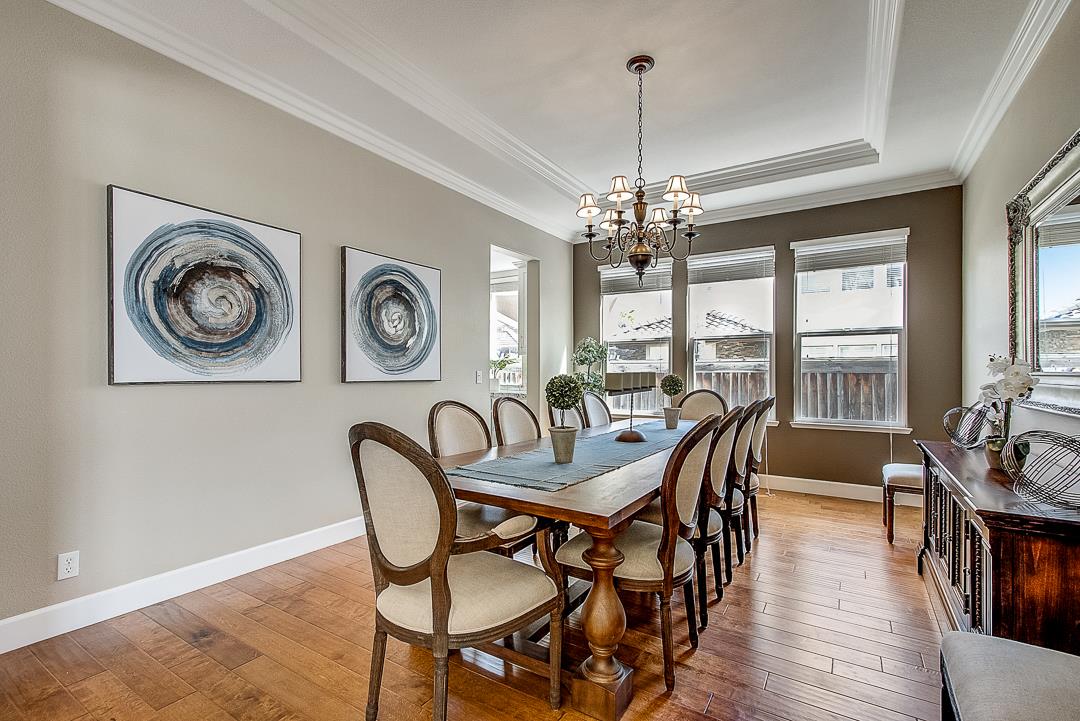7108 Lahinch Drive Gilroy, CA 95020 - Photo 9 of 50 a dining room with furniture a chandelier and wooden floor
