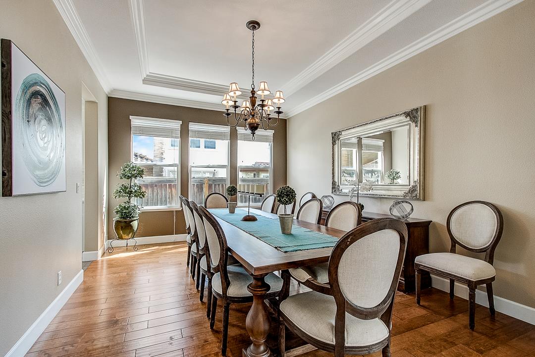 7108 Lahinch Drive Gilroy, CA 95020 - Photo 10 of 50 a dining room with furniture a chandelier and wooden floor