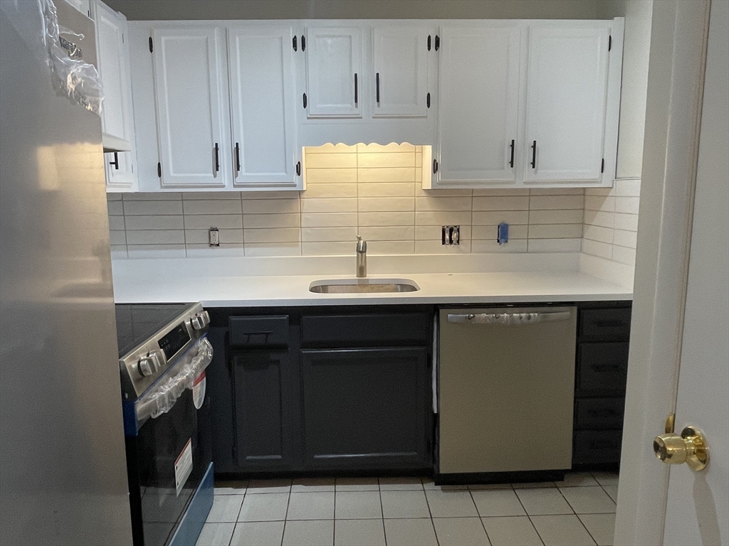 a kitchen with a sink and cabinets