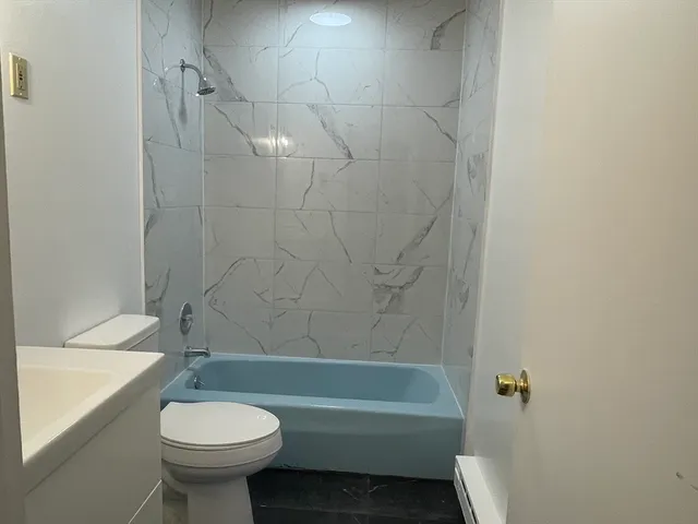 a bathroom with a sink a toilet and bathtub