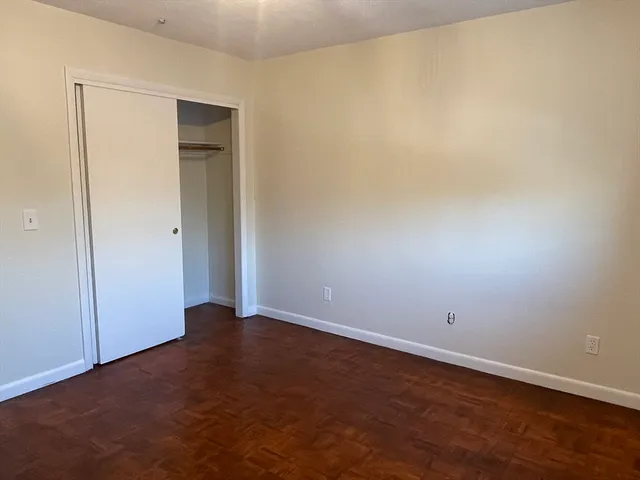 an empty room with wooden floor