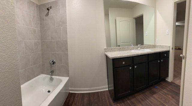 140 Allington Circle Jarrell, TX 76537 - Photo 13 of 23 Full bathroom with vanity, bathing tub / shower combination, and dark wood-type flooring