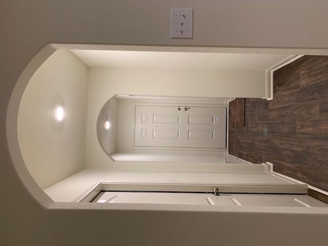 140 Allington Circle Jarrell, TX 76537 - Photo 16 of 23 Hallway featuring arched walkways and dark wood-type flooring